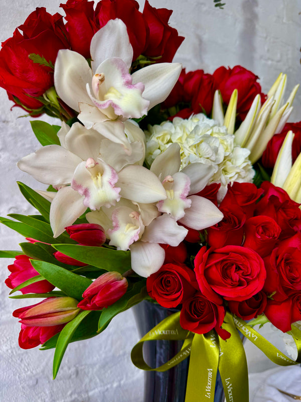 Frida, ramo de rosas rojas con hortensias y orquídeas y tulipanes.